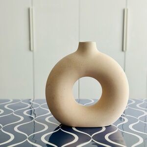 Minimalist Pale Beige Ceramic Vessel with Unique Torus Shape